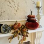 Luxury faux flower arrangement in soft autumnal tones styled in a cozy, neutral interior with seasonal textures.